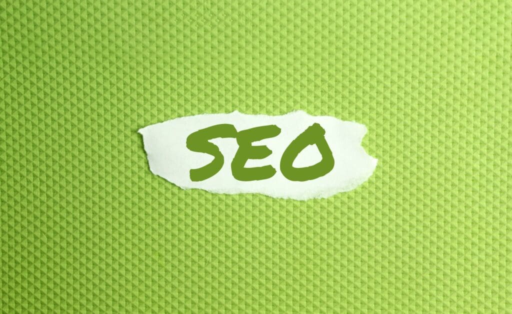 a torn paper written with inscription SEO on a green background